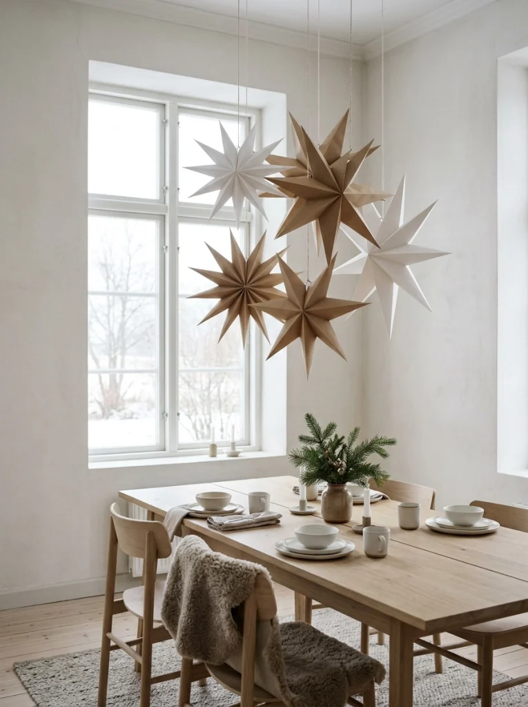 Minimalist Christmas home decor ideas featuring oversized folded paper stars in neutral colors.